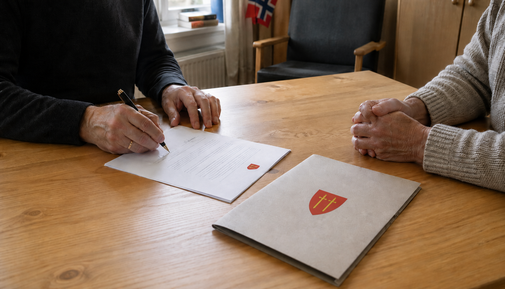 To personer signerer en avtale ved skrivebordet på Snartemo Quality Product